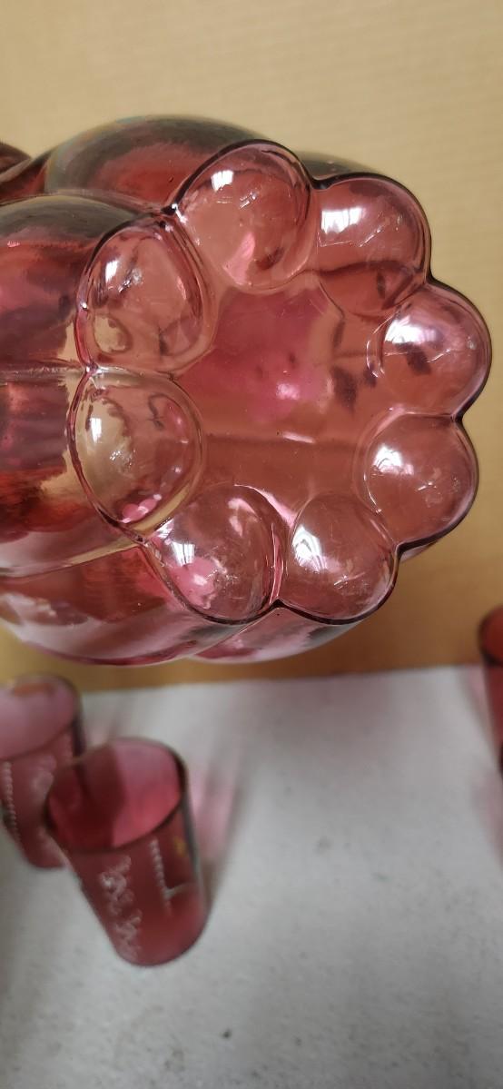 Sale Photo Thumbnail #198: Gorgeous Victorian cranberry pitcher and glasses with enamel paint. The pitcher is in excellent condition, the glasses are chippy