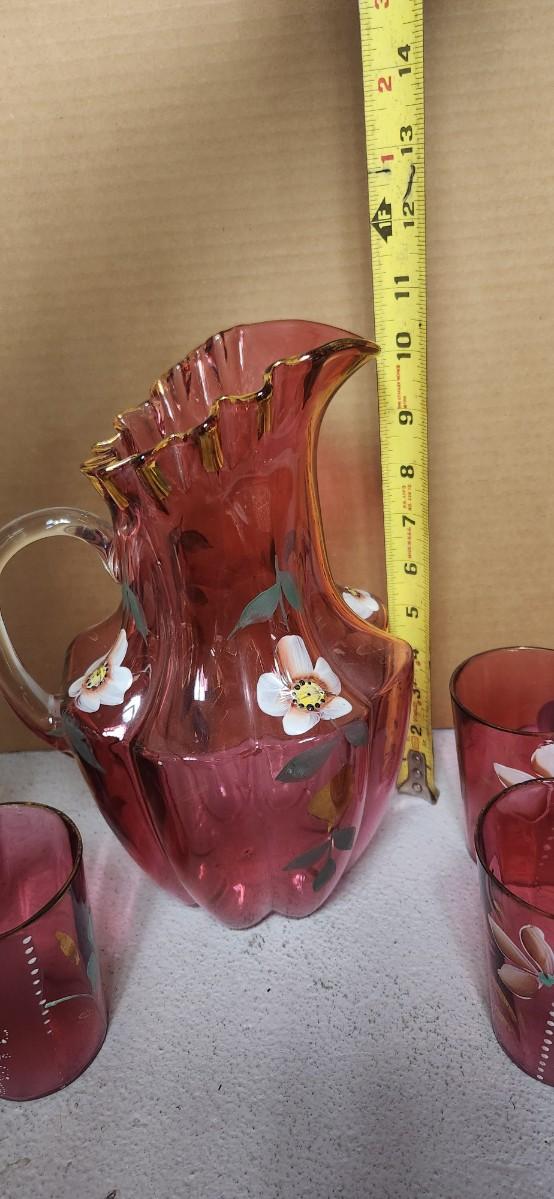 Sale Photo Thumbnail #195: Gorgeous Victorian cranberry pitcher and glasses with enamel paint. The pitcher is in excellent condition, the glasses are chippy