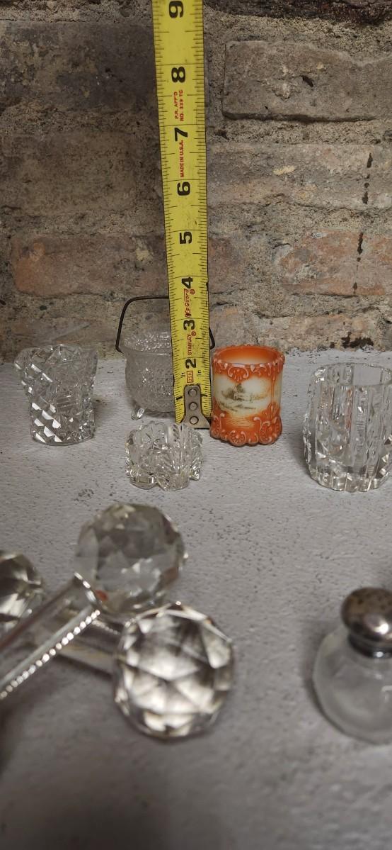 Sale Photo Thumbnail #304: Crystal toothpicks and salt cellar, a pair of antique knife rests...look at the cute shaker tops