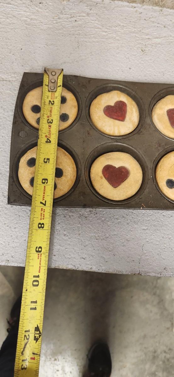 Sale Photo Thumbnail #312: Three old rocker cutters some inedible baked goods and their holders