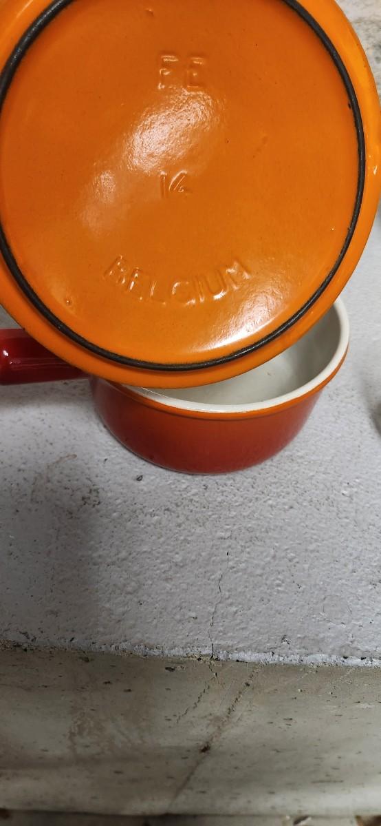 Sale Photo Thumbnail #403: That flame sauce pan enamel over cast with a wooden handle. A couple of pyrex pieces, some vintage lids etc