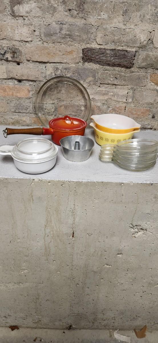 Sale Photo Thumbnail #394: That flame sauce pan enamel over cast with a wooden handle. A couple of pyrex pieces, some vintage lids etc