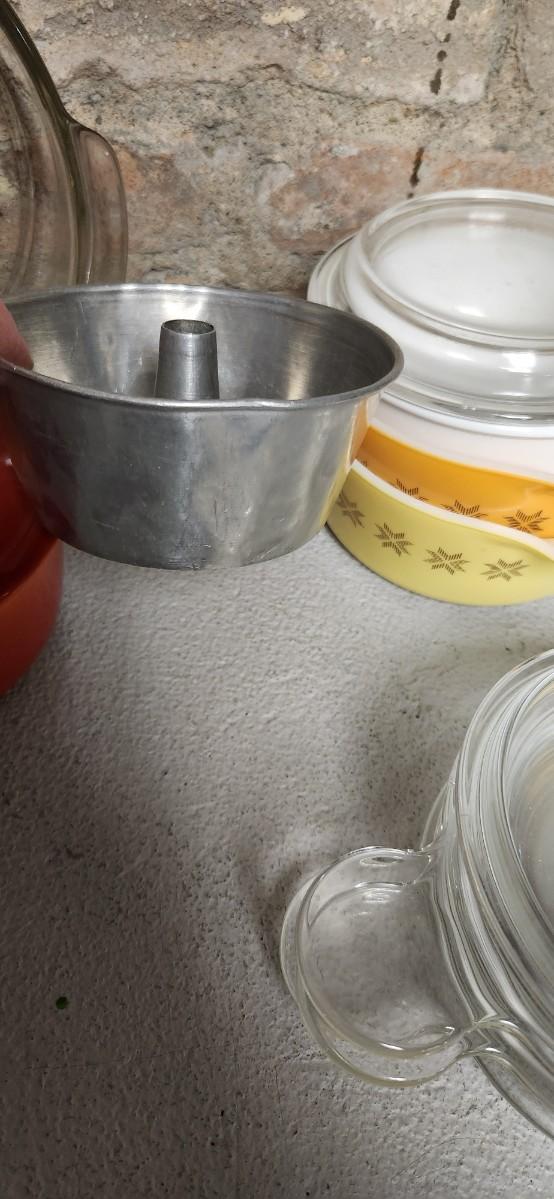 Sale Photo Thumbnail #401: That flame sauce pan enamel over cast with a wooden handle. A couple of pyrex pieces, some vintage lids etc