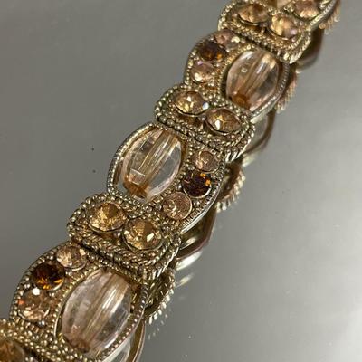 Gold tone bracelet with amber rhinestones