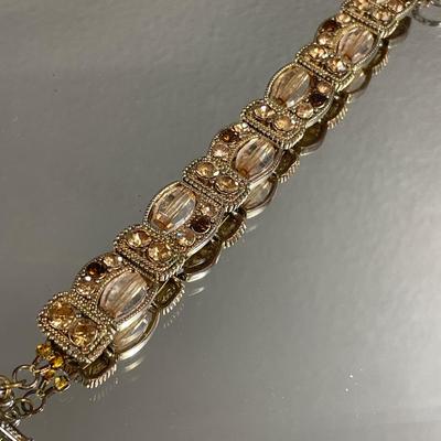 Gold tone bracelet with amber rhinestones