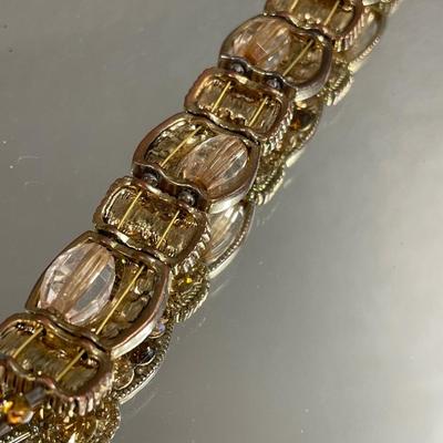 Gold tone bracelet with amber rhinestones