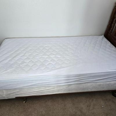 Twin sized bed with Brand new mattress & Boxsprings still in manufactured coverings - complete with quilted bedding