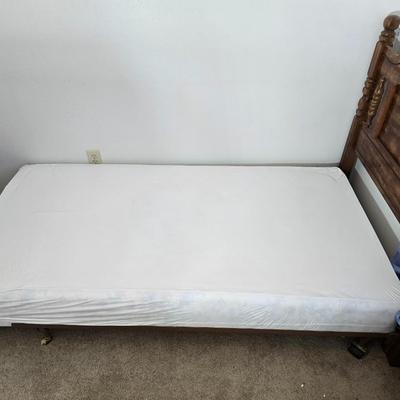 Twin sized bed with Brand new mattress & Boxsprings still in manufactured coverings - complete with quilted bedding