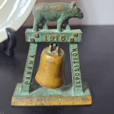 Antique cast iron souvenir bell from the 1915 Panama-California Exposition & a vintage souvenir plate featuring a depiction of Half...