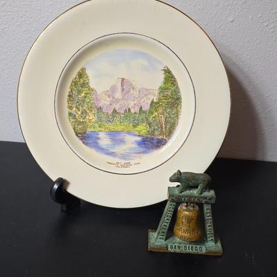 Antique cast iron souvenir bell from the 1915 Panama-California Exposition & a vintage souvenir plate featuring a depiction of Half...