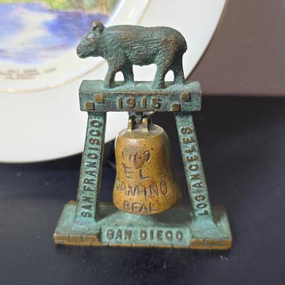Antique cast iron souvenir bell from the 1915 Panama-California Exposition & a vintage souvenir plate featuring a depiction of Half...