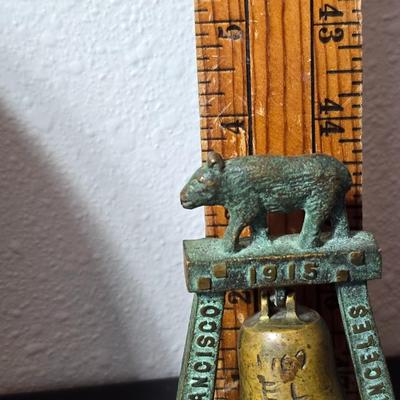 Antique cast iron souvenir bell from the 1915 Panama-California Exposition & a vintage souvenir plate featuring a depiction of Half...