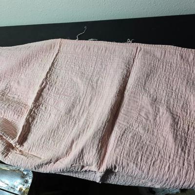 Tin sided luggage with an assortment of vintage children's clothes and baby quilt