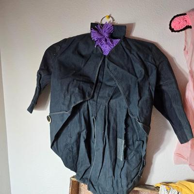 Tin sided luggage with an assortment of vintage children's clothes and baby quilt