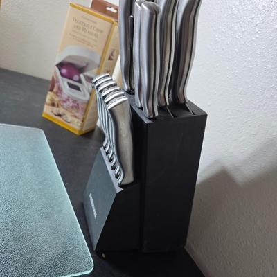 Farberware knife set in Knife block, glass cutting board, Williams Sonoma Vegetable chopper and a Harry & David Contour Pear bamboo...