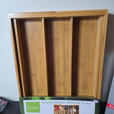 Bamboo Expandable utensil tray with an assortment of utensils and two cat themed dish towels