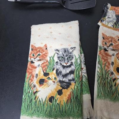 Bamboo Expandable utensil tray with an assortment of utensils and two cat themed dish towels