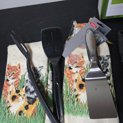 Bamboo Expandable utensil tray with an assortment of utensils and two cat themed dish towels