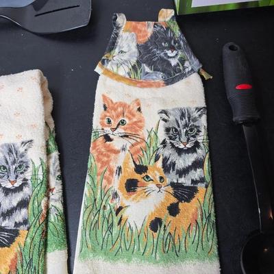 Bamboo Expandable utensil tray with an assortment of utensils and two cat themed dish towels