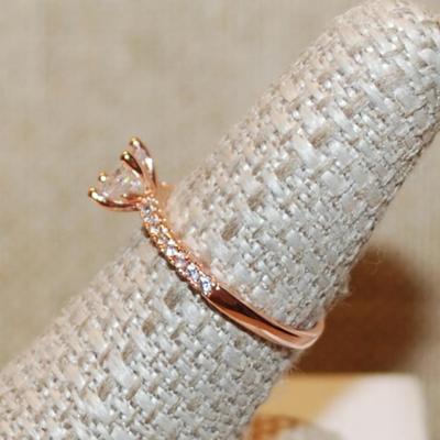 Size 7 Rose Gold 4 Prong Round Clear Main Stone Ring with 8 Accent Stone on Each Side on a Rose Gold Band (2.0g)