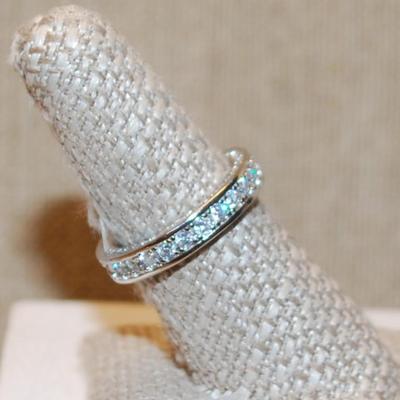 Size 8 Infinity Style Ring with Full Row of Round Clear Stones on a Silver Tone Band (4.7g)