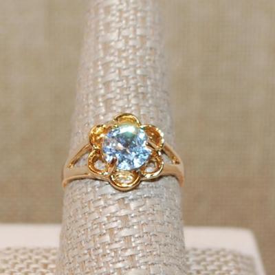 Size 9 Very Light Blue Single Stone Ring on a "Flower" Style Gold Tone Band (3.2g)