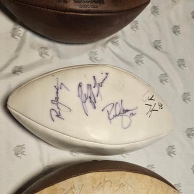 3 footballs 2 of them are signed by Eagles