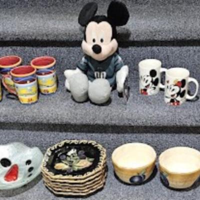 Mickey Mouse cups, Philly Eagles stuffed toy, and misc dishes