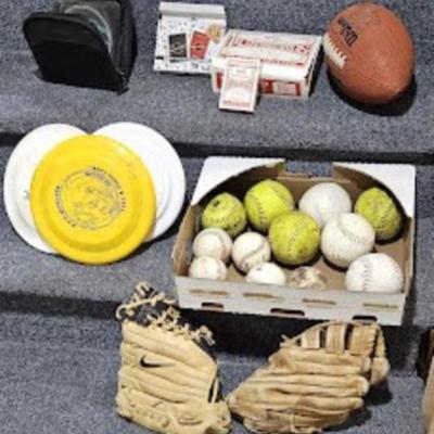 Footballs, baseballs, playing cards, card game, CD's in case, (3) frisbees, (2) baseball gloves,