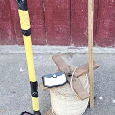 Big spool of heavy nursery twine, working solar light, and uce scraper/car brush
