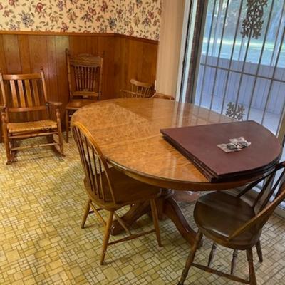 Sale Photo Thumbnail #7: A very nice table with 4 chairs and table pad & also a glass top.The chairs do not all match dimensions are 30" tall 60" long & 48 deep
