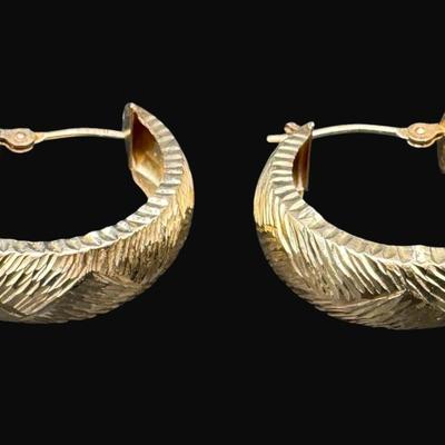 Sale Photo Thumbnail #103: **WIRE TRANSFER IS REQUIRED IF SHIPPED.** [1.72g] These diamond cut earrings are fashioned in yellow gold. There are some minor dents on the inside of these hoops when viewed under magnification. Approximate diameter is .75". **ALL PRECIOUS METALS SALES A