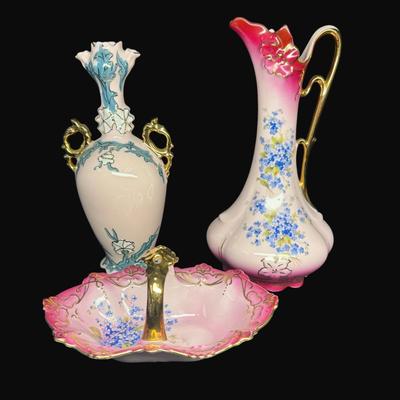 Sale Photo Thumbnail #157: Pink in color, with gold accents. Includes an Art Nouveau vase (9"H), a handled carafe (9.5"), and a handled candy dish. Total of three pieces. [RE]