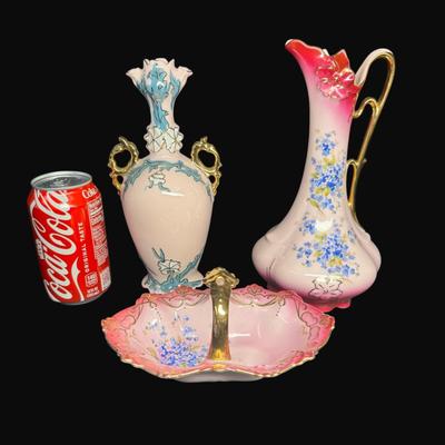 Sale Photo Thumbnail #158: Pink in color, with gold accents. Includes an Art Nouveau vase (9"H), a handled carafe (9.5"), and a handled candy dish. Total of three pieces. [RE]