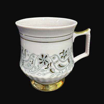 Sale Photo Thumbnail #169: Footed mug set with gold accents. Age related wear. Total of four pieces. Measurement: 3.75"H (each). [RE]