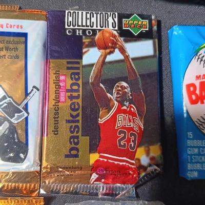 UNOPENED PACKAGES OF SPORTS TRADING CARDS