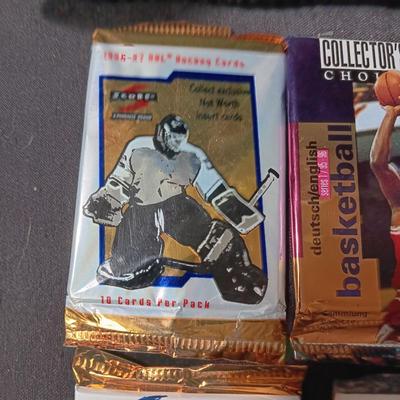 UNOPENED PACKAGES OF SPORTS TRADING CARDS