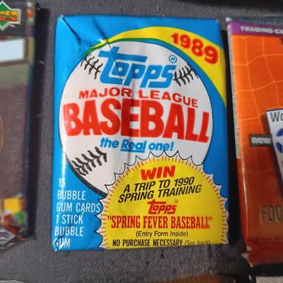 UNOPENED PACKAGES OF SPORTS TRADING CARDS