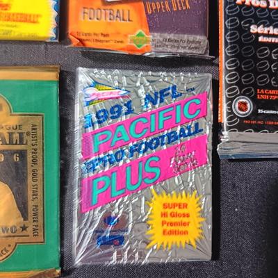 UNOPENED PACKAGES OF SPORTS TRADING CARDS