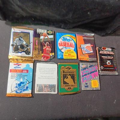 UNOPENED PACKAGES OF SPORTS TRADING CARDS