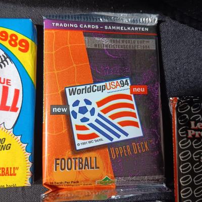UNOPENED PACKAGES OF SPORTS TRADING CARDS