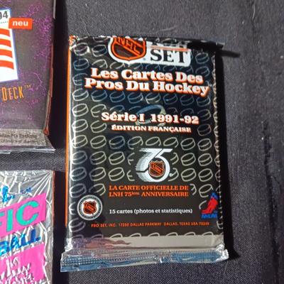 UNOPENED PACKAGES OF SPORTS TRADING CARDS