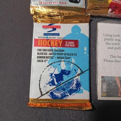 UNOPENED PACKAGES OF SPORTS TRADING CARDS