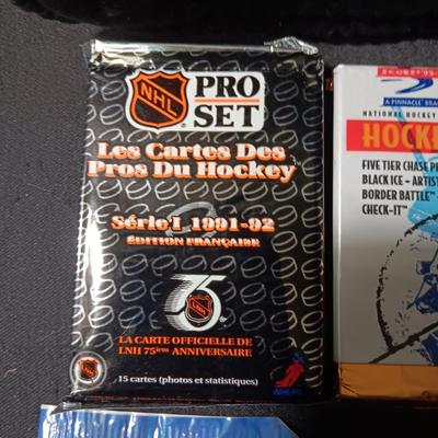 UNOPENED PACKAGES OF SPORTS TRADING CARDS