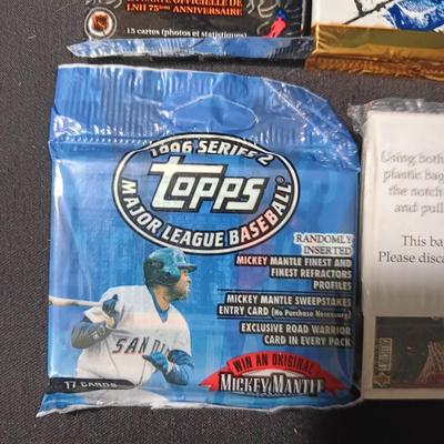 UNOPENED PACKAGES OF SPORTS TRADING CARDS