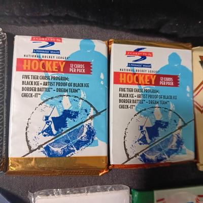 UNOPENED PACKAGES OF SPORTS TRADING CARDS