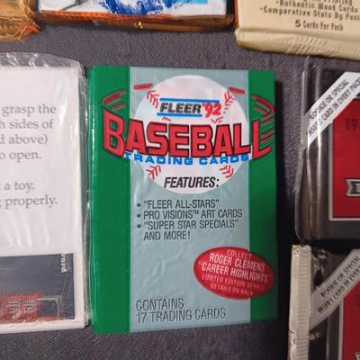 UNOPENED PACKAGES OF SPORTS TRADING CARDS