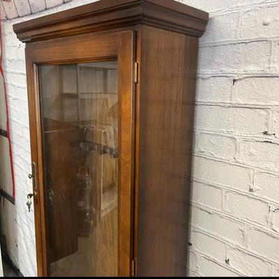 Sale Photo Thumbnail #44: 25×10×71 wooden cabinet with glass door and lower storage.