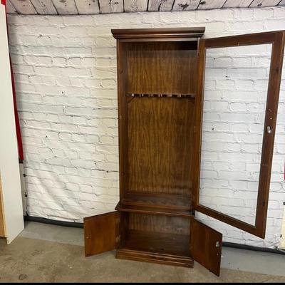 Sale Photo Thumbnail #40: 25×10×71 wooden cabinet with glass door and lower storage.