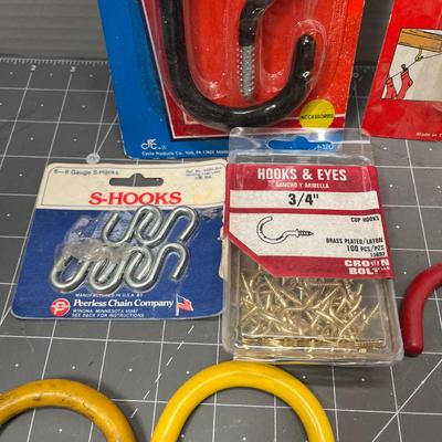 Sale Photo Thumbnail #92: Mixed lot of storage hooks, line or plant hooks, S-hooks, and hardware.